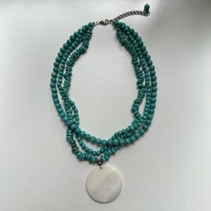 Three-Strand Turquoise Colored Bead Necklace With White Shell Pendant